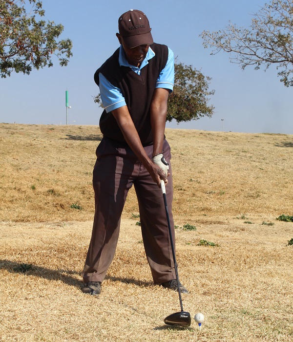 Golfer shooting on ball with driver club