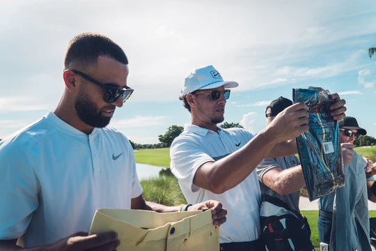 2 golfers unboxing clothes from short par 4